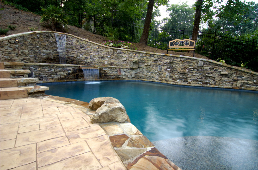Mid-sized country backyard custom-shaped natural pool in Atlanta with a water feature and brick pavers.