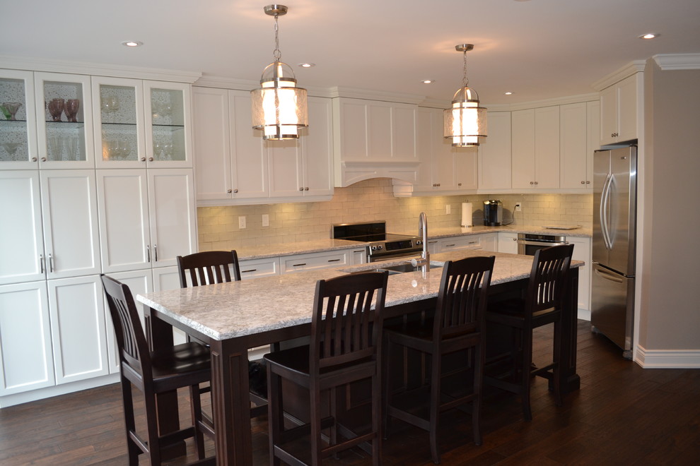 Mid-sized transitional single-wall dark wood floor open concept kitchen photo in Toronto with a double-bowl sink, recessed-panel cabinets, white cabinets, quartz countertops, gray backsplash, porcelain backsplash, stainless steel appliances and an island