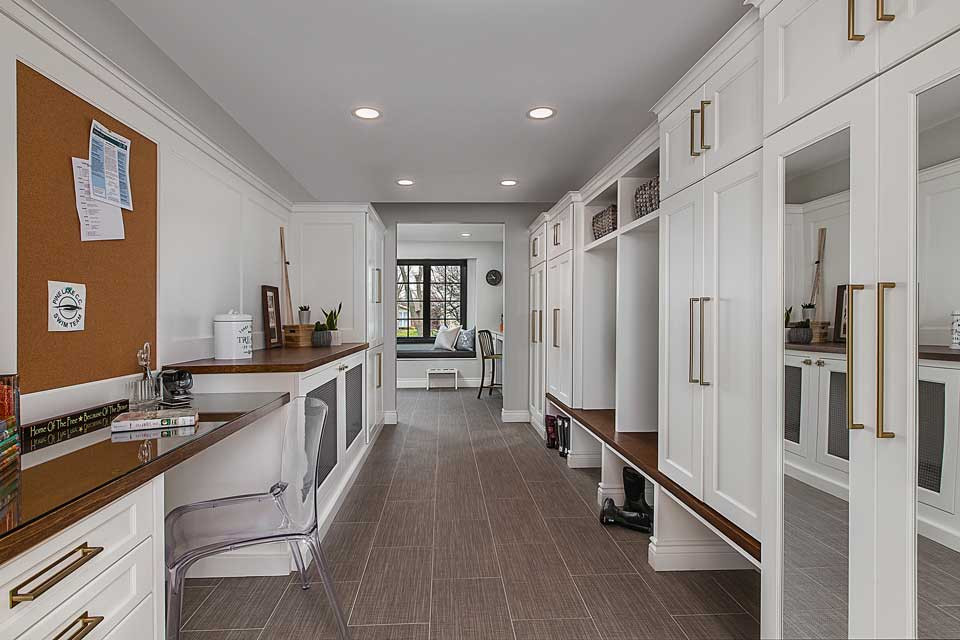 Design ideas for a large transitional galley utility room in Detroit with an undermount sink, recessed-panel cabinets, white cabinets, quartz benchtops, grey walls, porcelain floors, a side-by-side washer and dryer, beige floor, beige benchtop, white splashback, timber splashback and panelled walls.