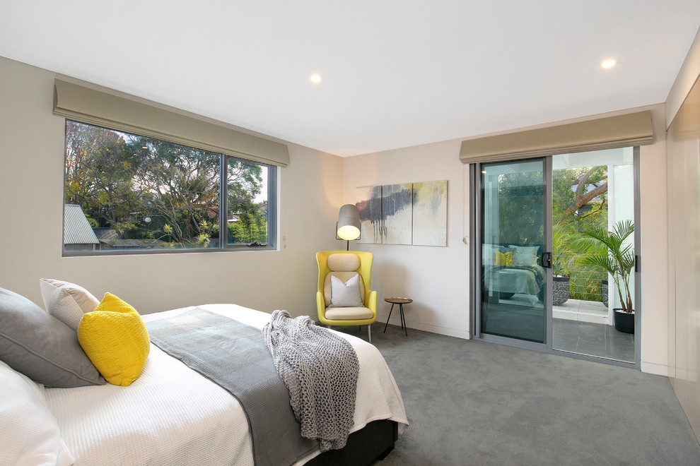 Photo of a mid-sized contemporary master bedroom in Sydney with beige walls, carpet, grey floor and no fireplace.