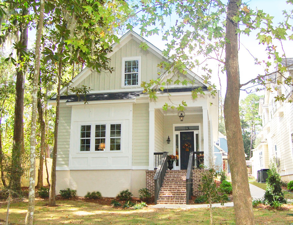 This is an example of a mid-sized arts and crafts two-storey beige exterior in Atlanta with concrete fiberboard siding and a gable roof.