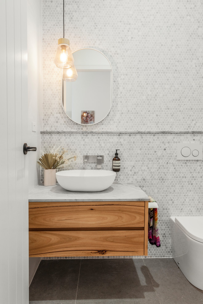Ejemplo de cuarto de baño único y flotante actual de tamaño medio con baldosas y/o azulejos de mármol y encimera de mármol