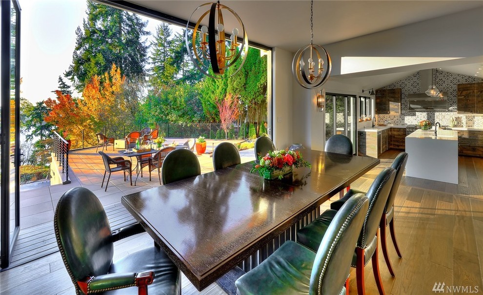 Photo of a large contemporary open plan dining in Seattle with white walls and light hardwood floors.