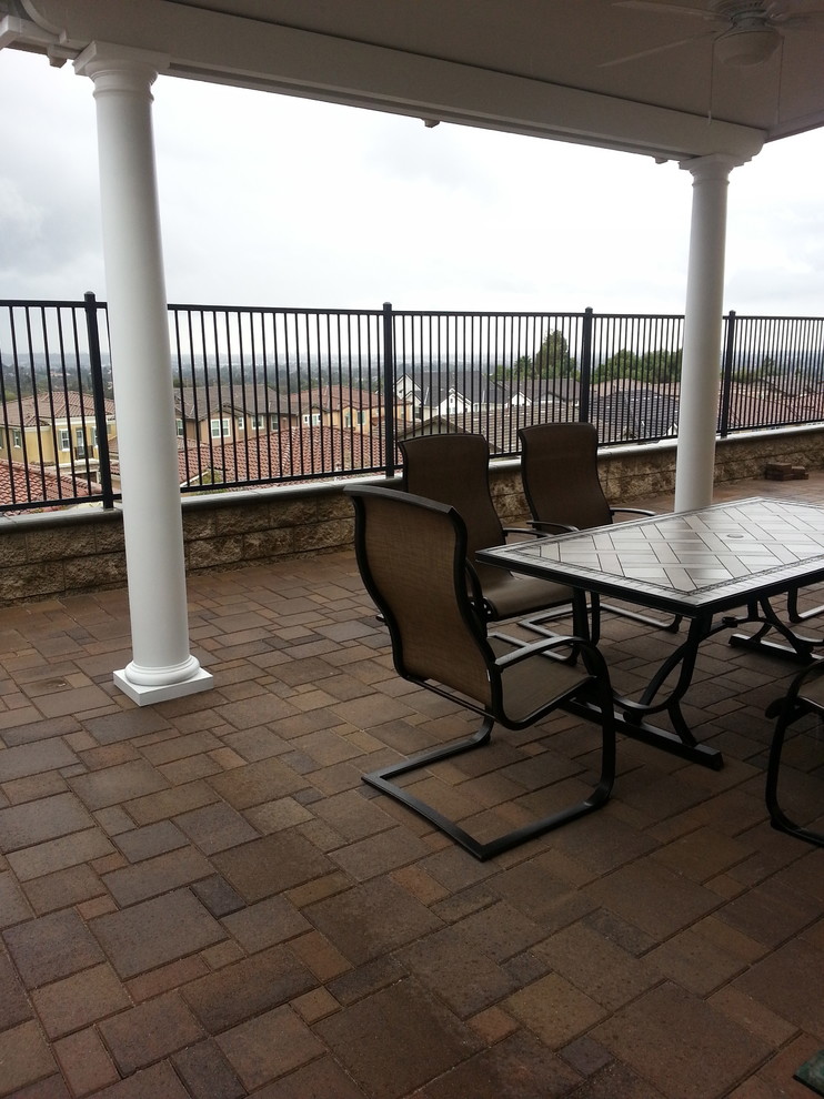 Example of a mid-sized transitional rooftop deck design in Orange County with a roof extension