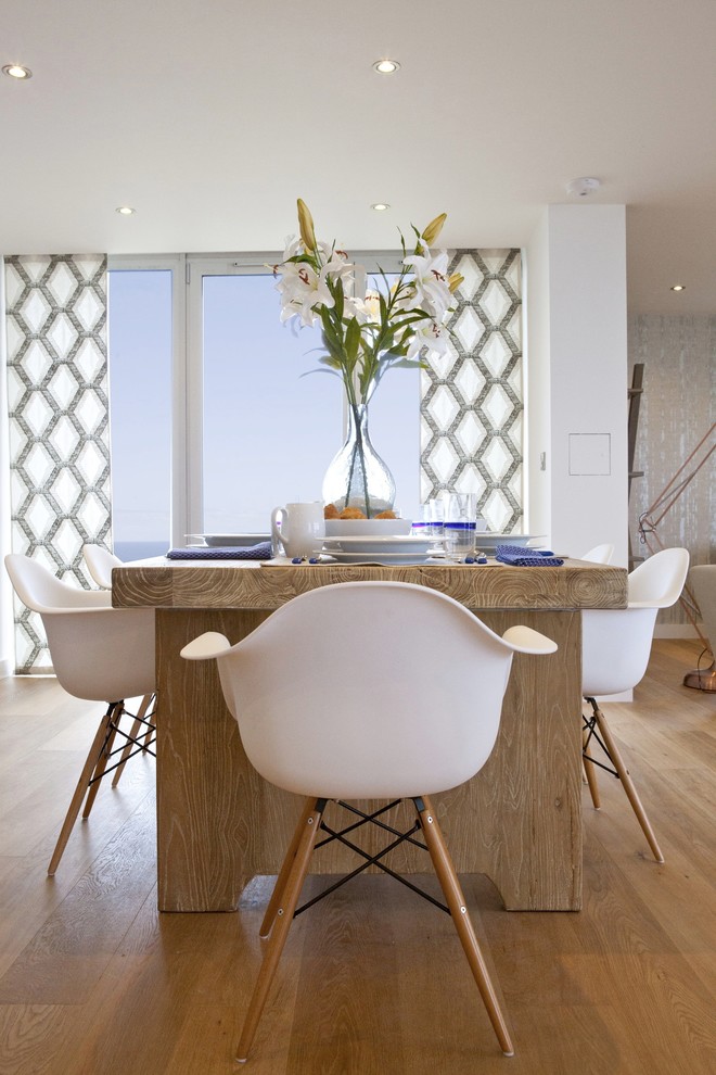 This is an example of a beach style dining room in Cornwall.