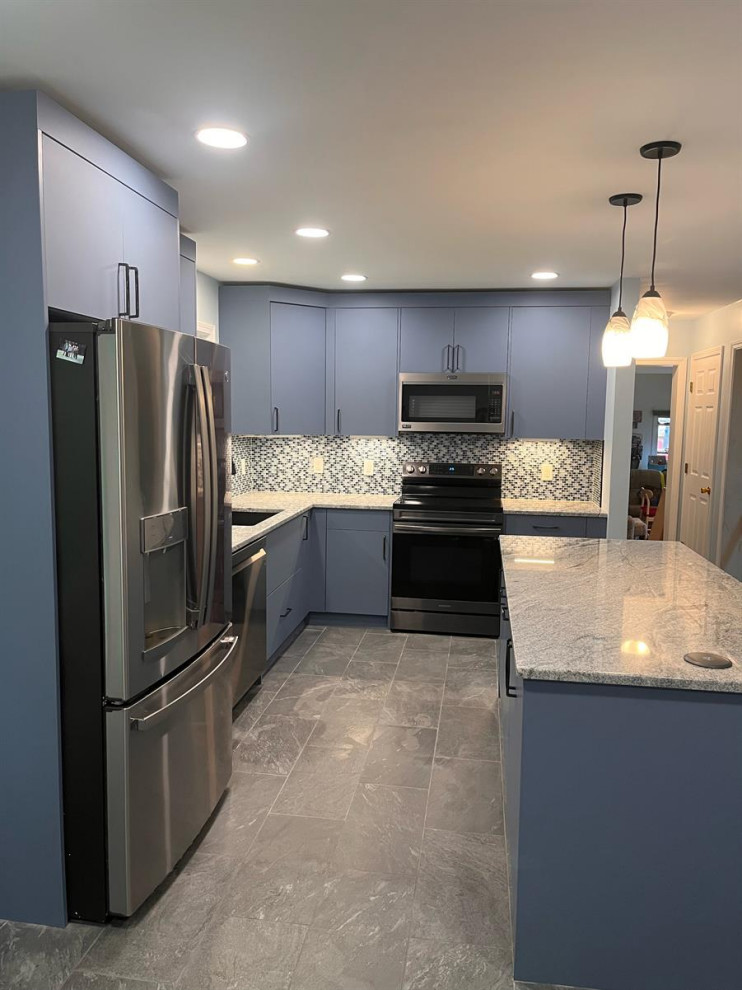 This is an example of a modern l-shaped dedicated laundry room in Bridgeport with flat-panel cabinets, blue cabinets, granite benchtops, black splashback, mosaic tile splashback, grey walls and yellow benchtop.