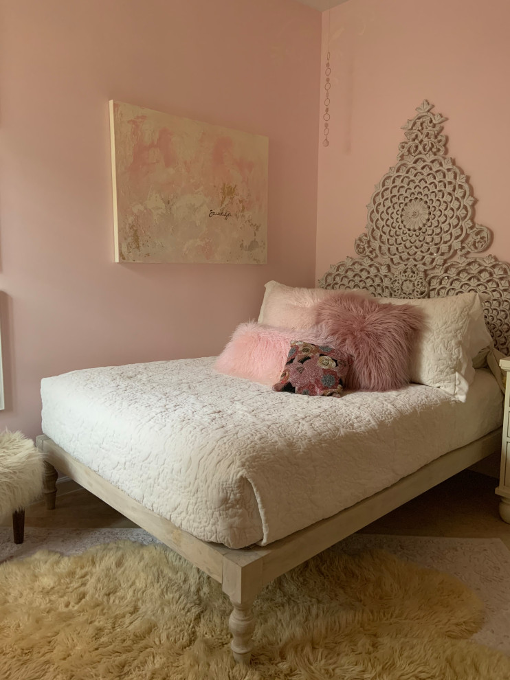 This is an example of a small eclectic bedroom in Miami with pink walls, travertine floors and beige floor.