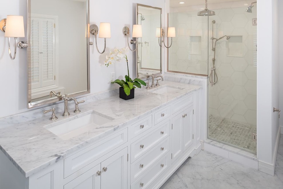 Inspiration for a mid-sized transitional master bathroom in New York with an alcove shower, white walls, linoleum floors, an undermount sink, white floor, a hinged shower door, beaded inset cabinets, white cabinets, a freestanding tub and marble benchtops.