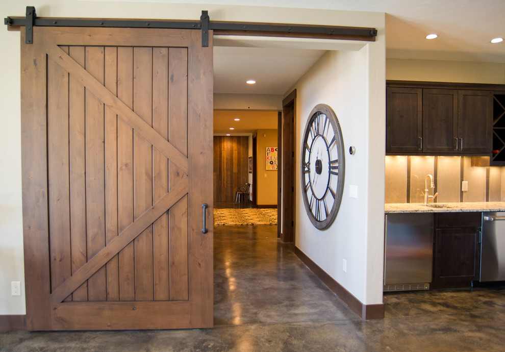 This is an example of a country basement in Denver with concrete floors.
