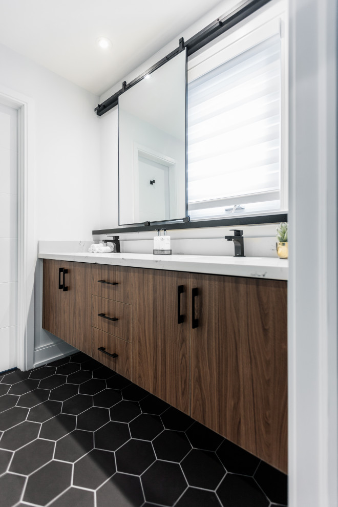 This is an example of a large contemporary 3/4 bathroom in Toronto with flat-panel cabinets, medium wood cabinets, an open shower, a one-piece toilet, white tile, porcelain tile, white walls, porcelain floors, an undermount sink, engineered quartz benchtops, black floor, a hinged shower door, white benchtops, a niche, a double vanity and a floating vanity.