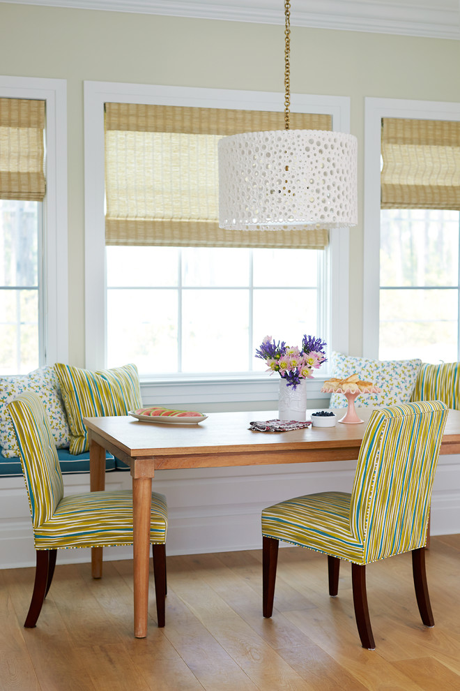 Inspiration for a beach style dining room in Jacksonville with beige walls and medium hardwood floors.