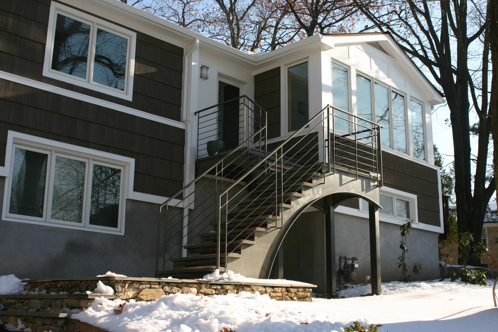 This is an example of a mid-sized contemporary two-storey grey exterior in New York with mixed siding and a gable roof.