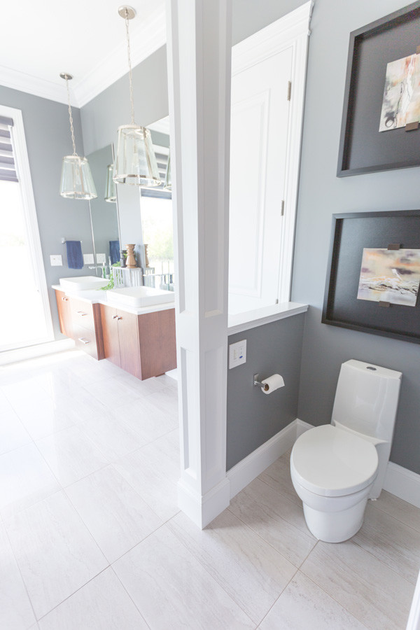 Inspiration for a transitional master beige tile beige floor bathroom remodel with flat-panel cabinets, medium tone wood cabinets, gray walls and a vessel sink