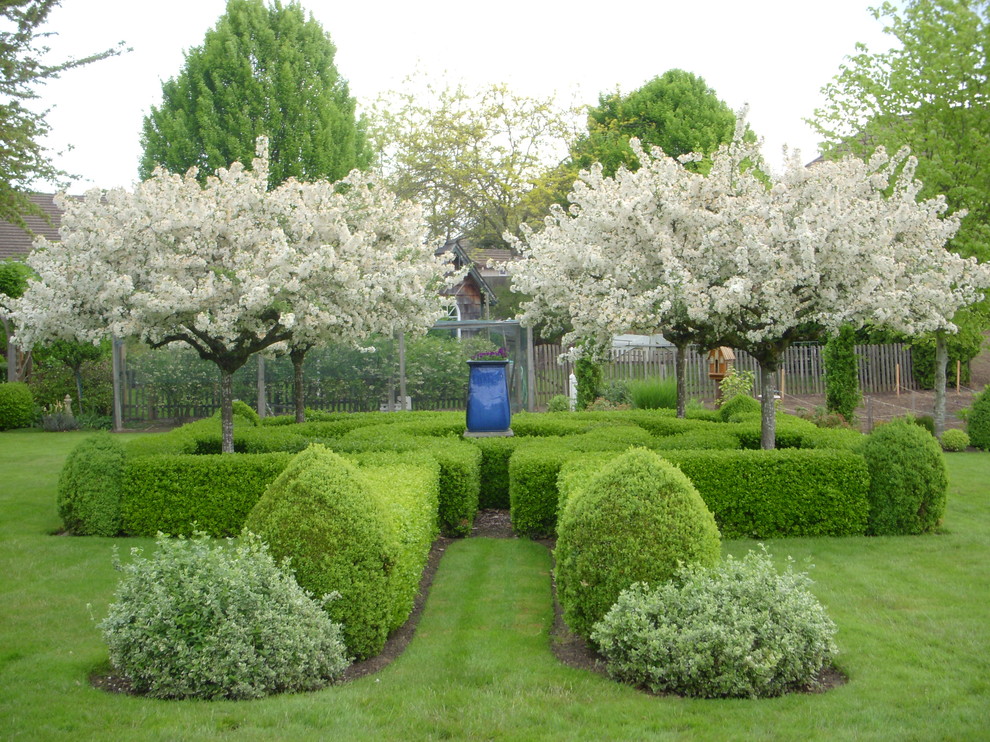 This is an example of a mid-sized traditional backyard formal garden in Portland.