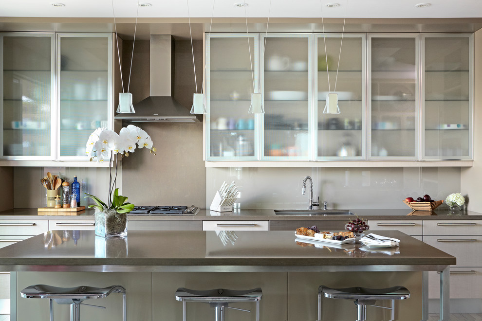 This is an example of a contemporary kitchen in Toronto with glass-front cabinets.