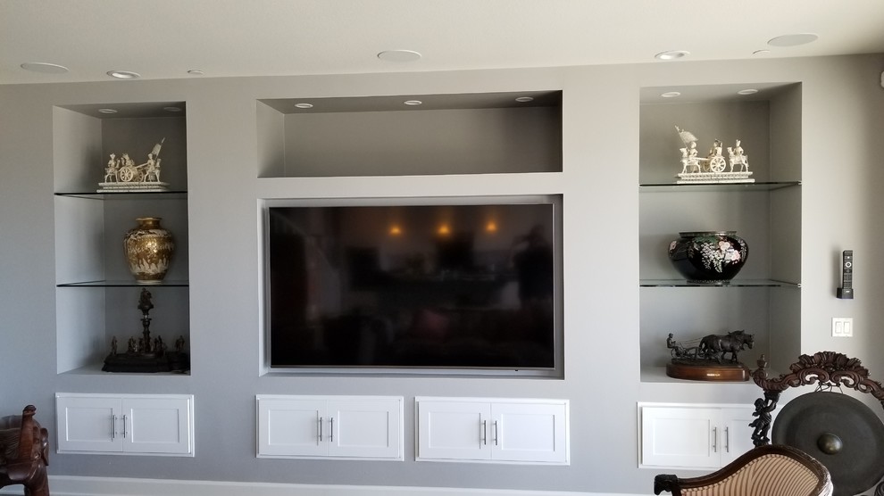 Inspiration for a large modern open concept home theatre in San Diego with a built-in media wall.