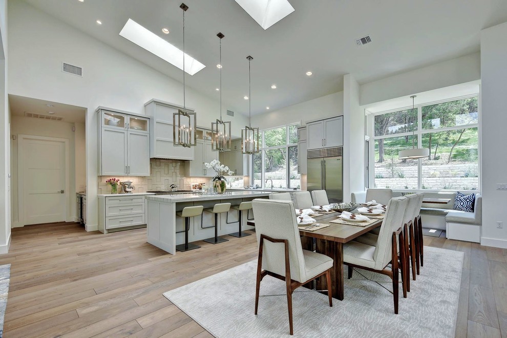 Design ideas for a large transitional eat-in kitchen in Austin with an undermount sink, shaker cabinets, granite benchtops, beige splashback, ceramic splashback, stainless steel appliances, with island and grey cabinets.