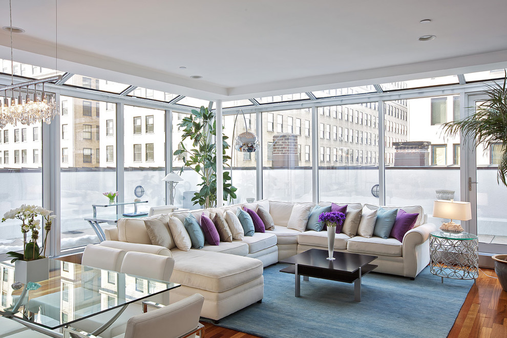 This is an example of a contemporary living room in New York with medium hardwood floors.