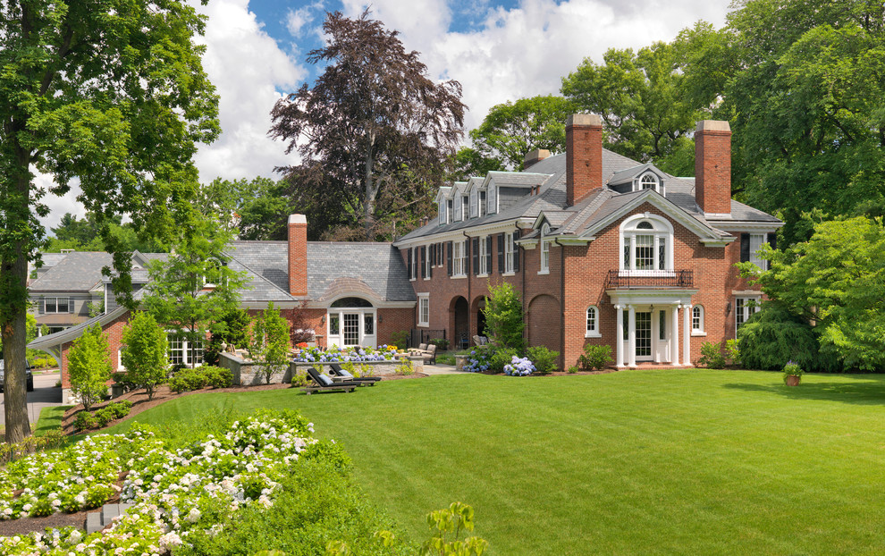Design ideas for a large traditional brick exterior in Boston with a hip roof.