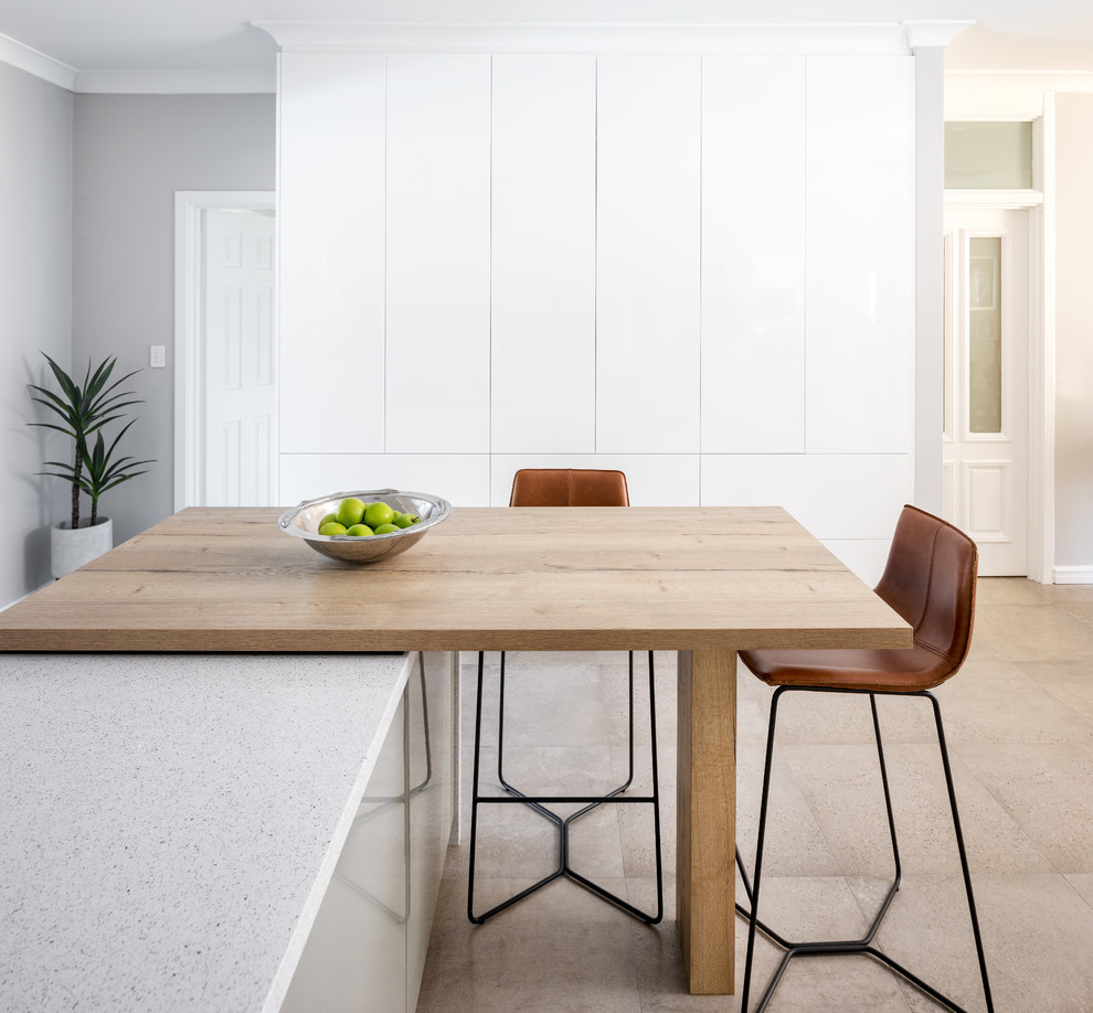 Modern kitchen in Perth with flat-panel cabinets, white cabinets, quartz benchtops, with island and white benchtop.