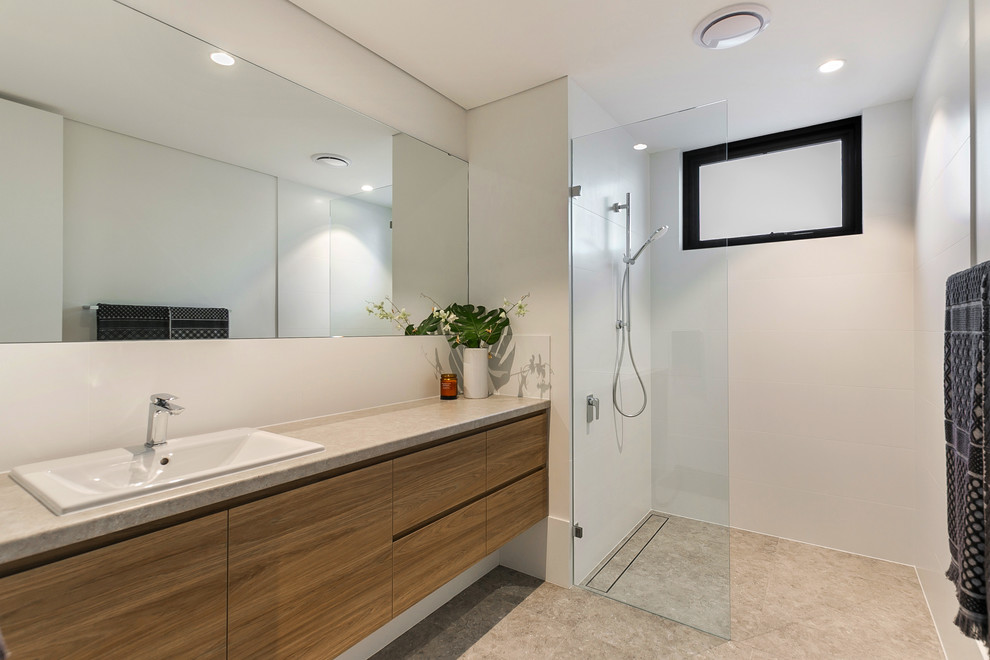 Inspiration for a modern 3/4 bathroom in Perth with light wood cabinets, an alcove shower, white tile, porcelain tile, white walls, porcelain floors, an undermount sink, limestone benchtops, grey floor, an open shower and grey benchtops.