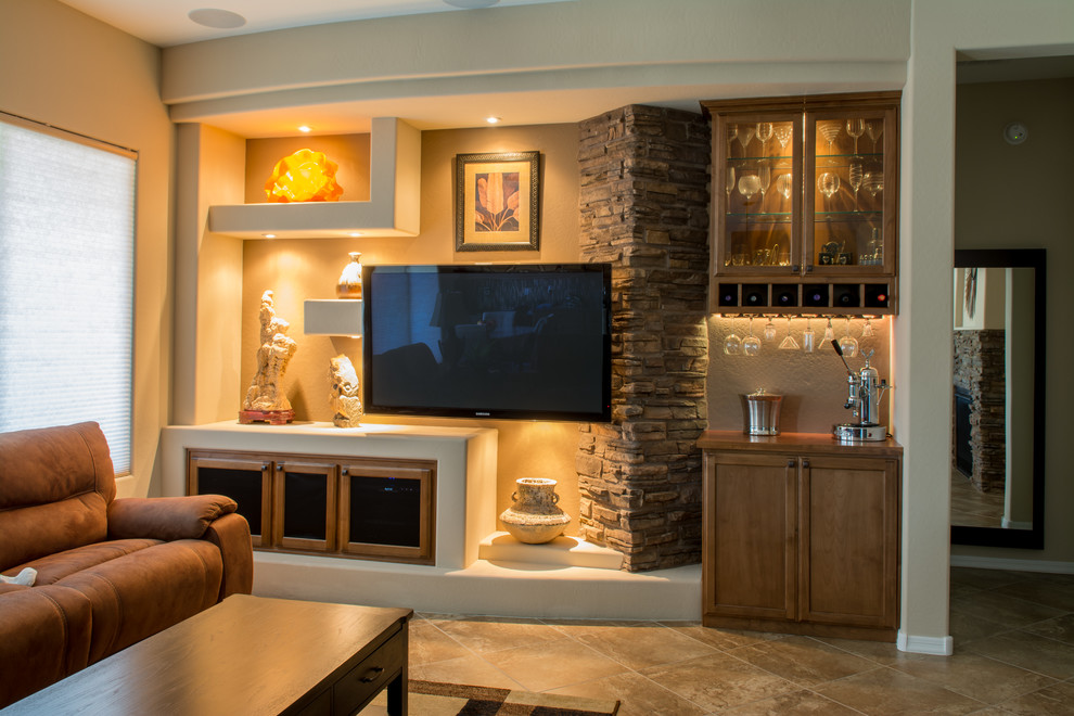 Photo of a mid-sized traditional open concept living room in Phoenix with a home bar, beige walls, travertine floors, no fireplace, a wall-mounted tv and beige floor.