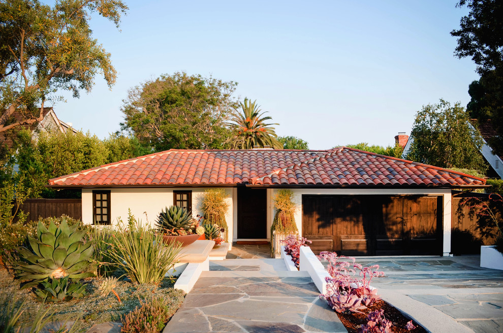 Design ideas for a mid-sized mediterranean one-storey stucco white house exterior in Los Angeles with a hip roof and a tile roof.