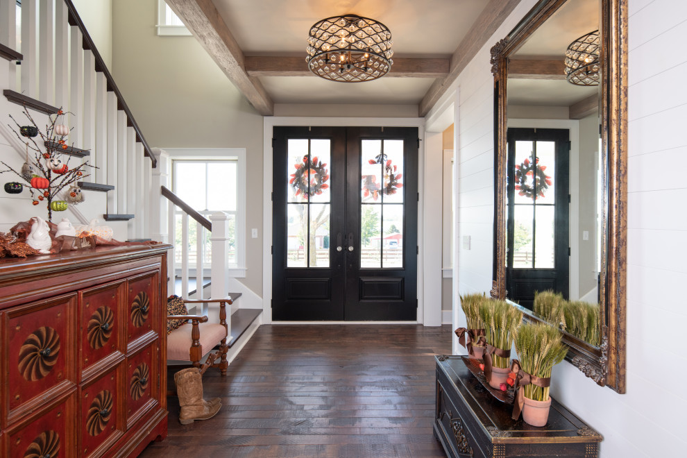 Photo of a country entry hall in Kansas City with a double front door and planked wall panelling.