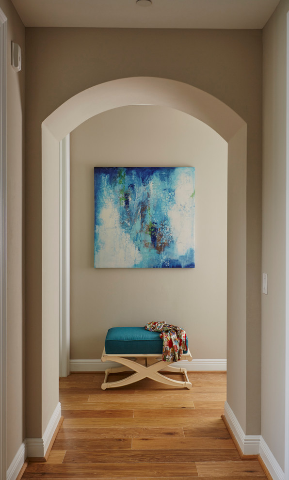 Hallway - mid-sized transitional medium tone wood floor hallway idea in Miami with blue walls and a white front door