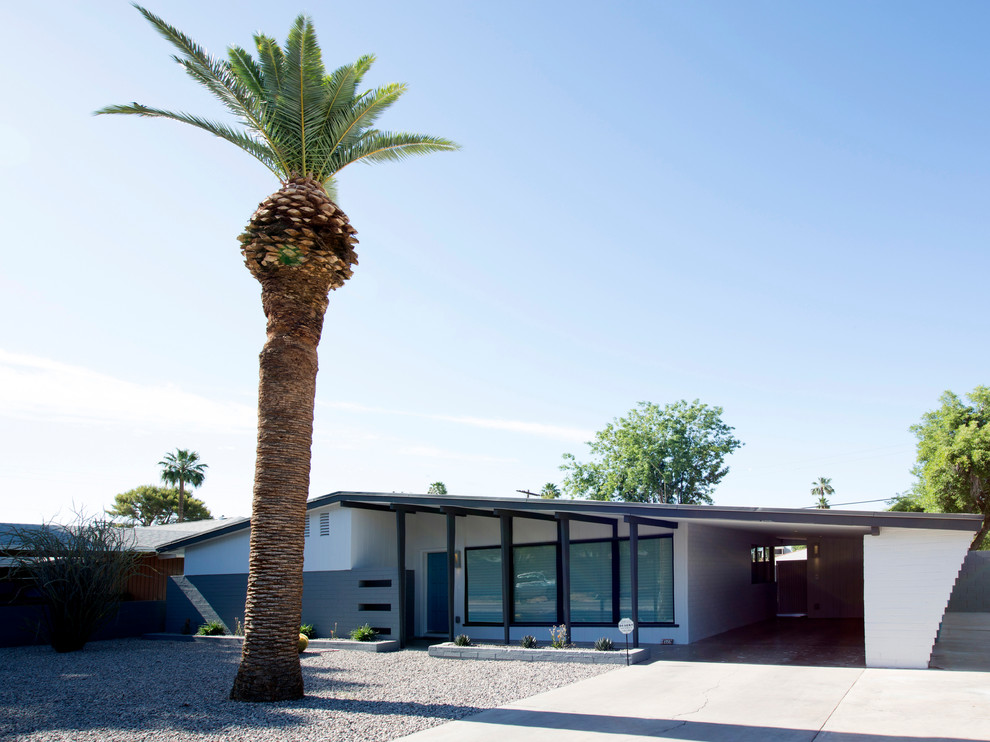 Design ideas for a midcentury one-storey white exterior in Phoenix with mixed siding.