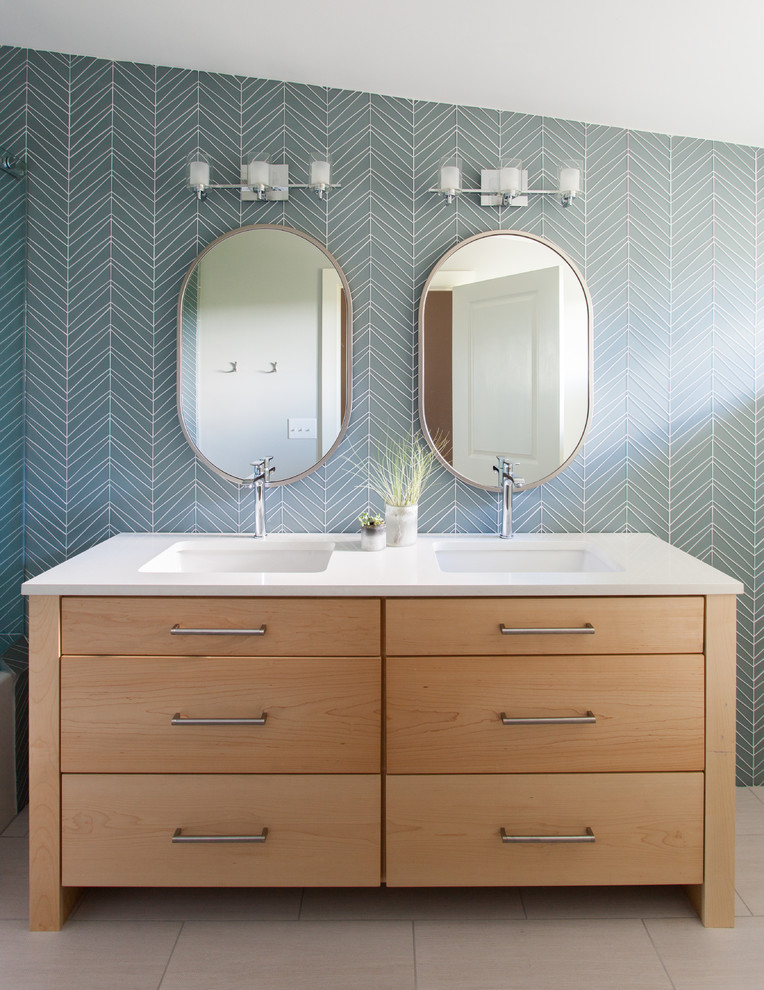 Small transitional bathroom photo in Austin with light wood cabinets, solid surface countertops, an undermount sink, multicolored walls and flat-panel cabinets