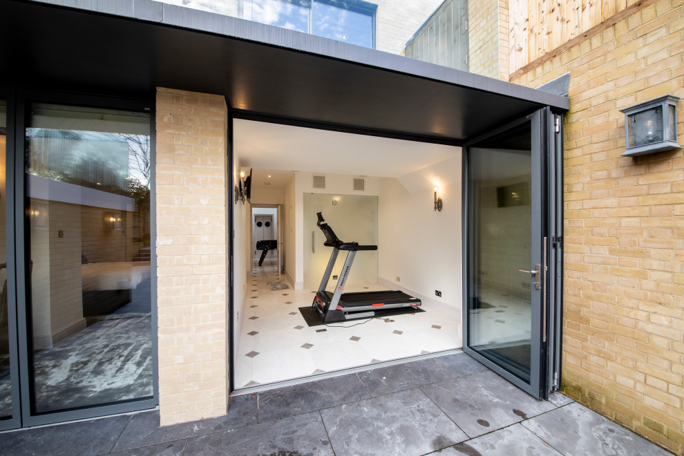 Inspiration for a mid-sized contemporary multipurpose gym in Wiltshire with white walls, ceramic floors and white floor.