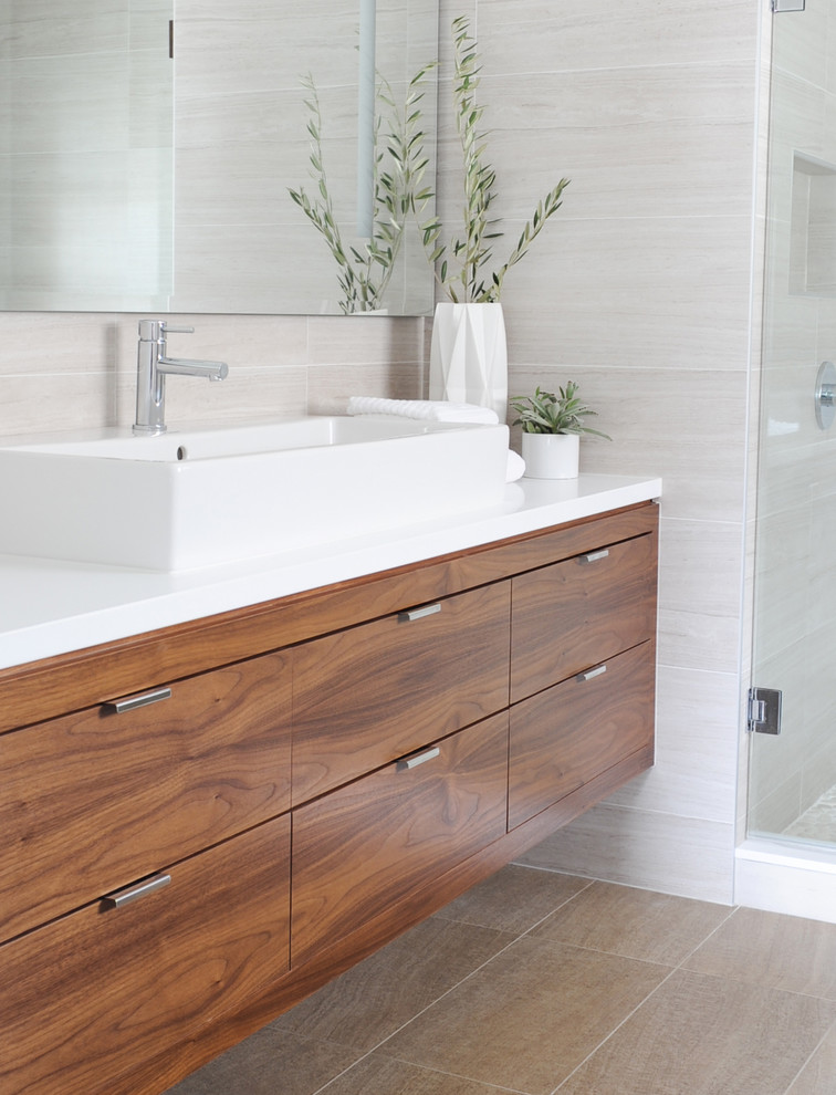 This is an example of a mid-sized contemporary master bathroom in Vancouver with flat-panel cabinets, medium wood cabinets, an open shower, gray tile, porcelain tile, a vessel sink and engineered quartz benchtops.