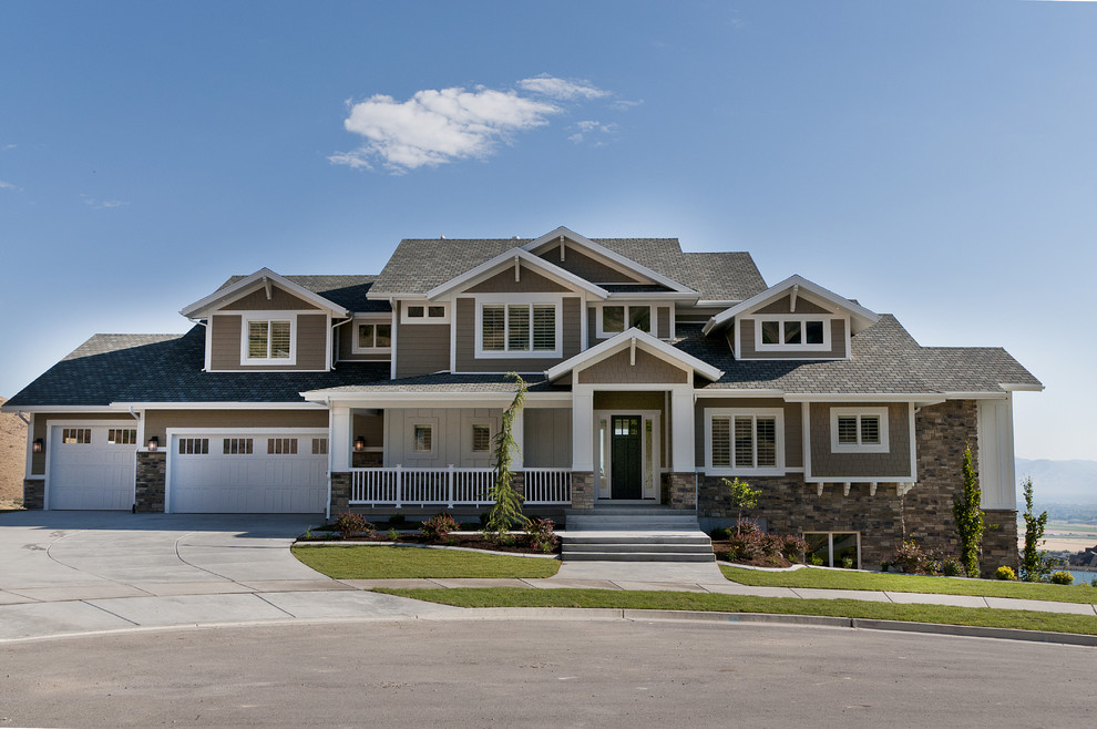 This is an example of a large arts and crafts two-storey exterior in Salt Lake City with wood siding.