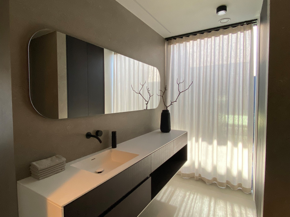 Photo of a mid-sized modern bathroom in Frankfurt with flat-panel cabinets, dark wood cabinets, ceramic floors, a drop-in sink, solid surface benchtops, grey floor, white benchtops, a laundry, a single vanity and a floating vanity.