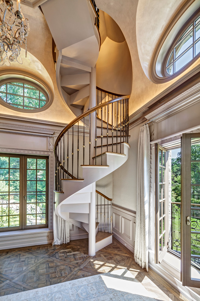 Traditional wood spiral staircase in New York with wood risers.