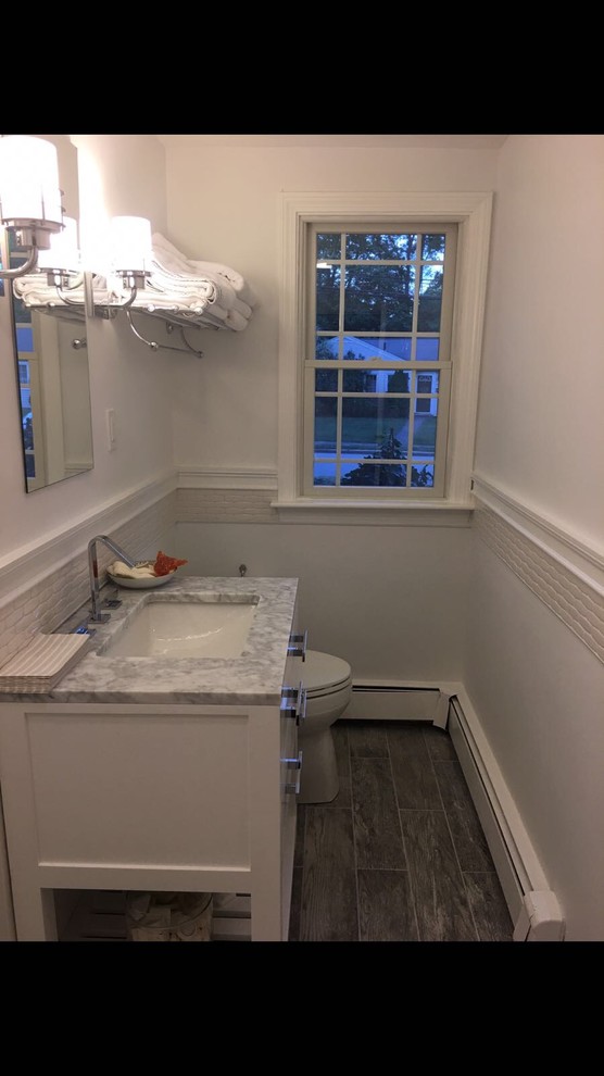 Photo of a mid-sized traditional 3/4 bathroom in Boston with a corner shower, white tile, white walls, an undermount sink, an open shower, raised-panel cabinets, white cabinets and marble benchtops.