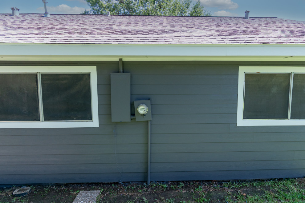 Back of house with new Hardie siding with cables and wires removed.
