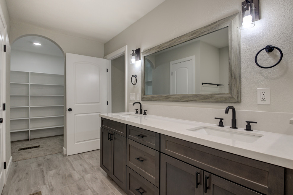 Freestanding bathtub - mid-sized transitional master white tile and subway tile double-sink freestanding bathtub idea in Phoenix with shaker cabinets, brown cabinets, an undermount sink, quartz countertops, white countertops and a built-in vanity