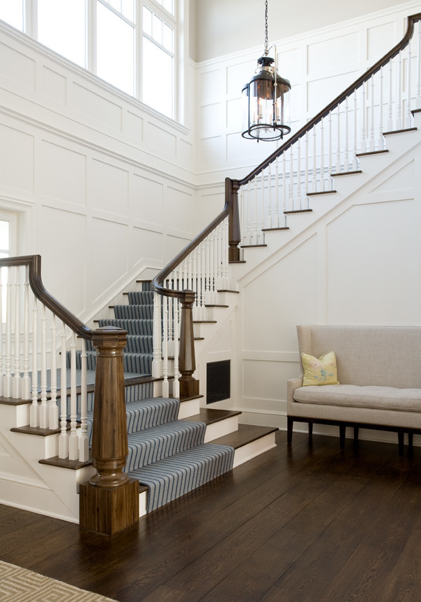 This is an example of an expansive beach style carpeted l-shaped staircase in New York.