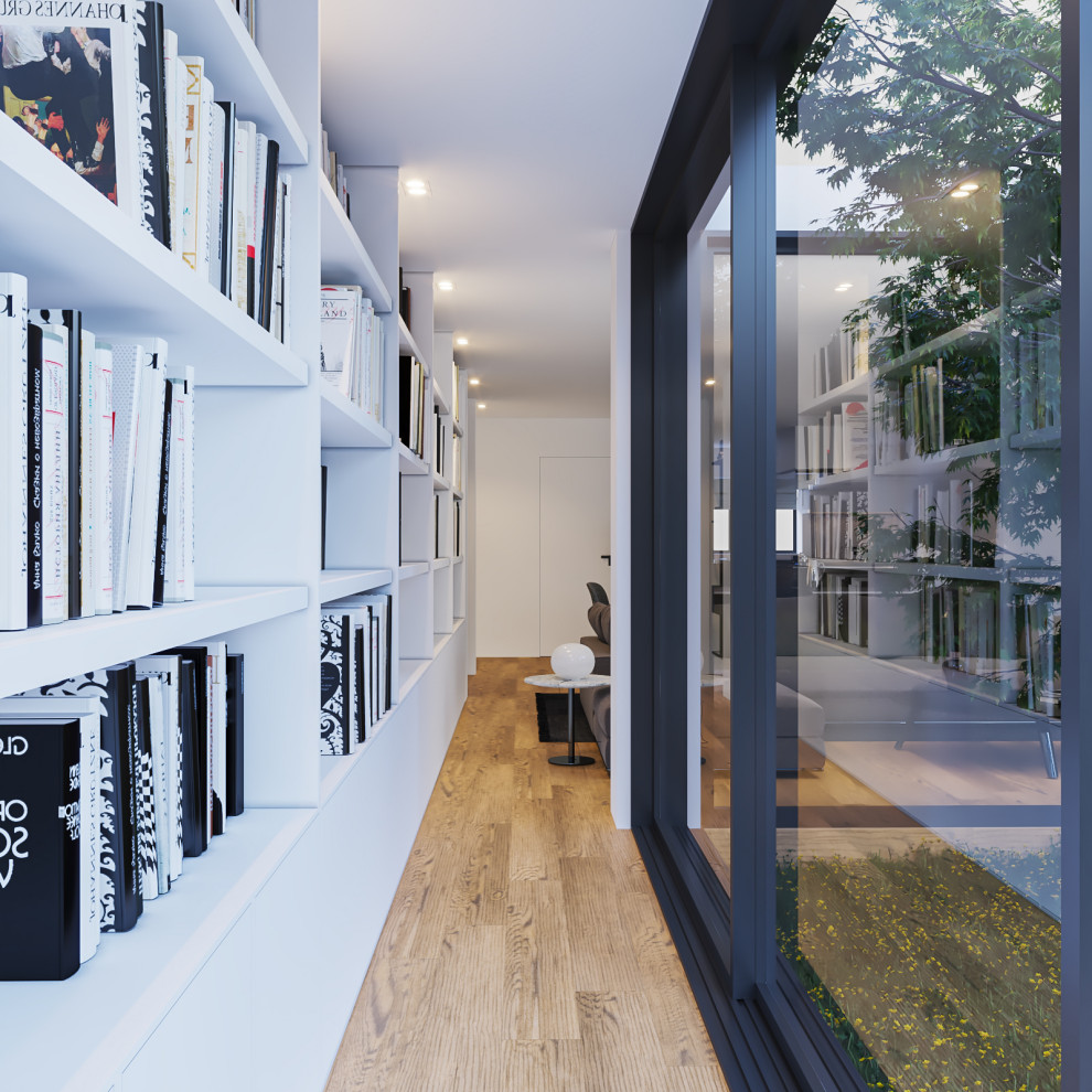 This is an example of a medium sized contemporary cream and black open plan living room in Cambridgeshire with brown floors, a reading nook, white walls, light hardwood flooring and no tv.