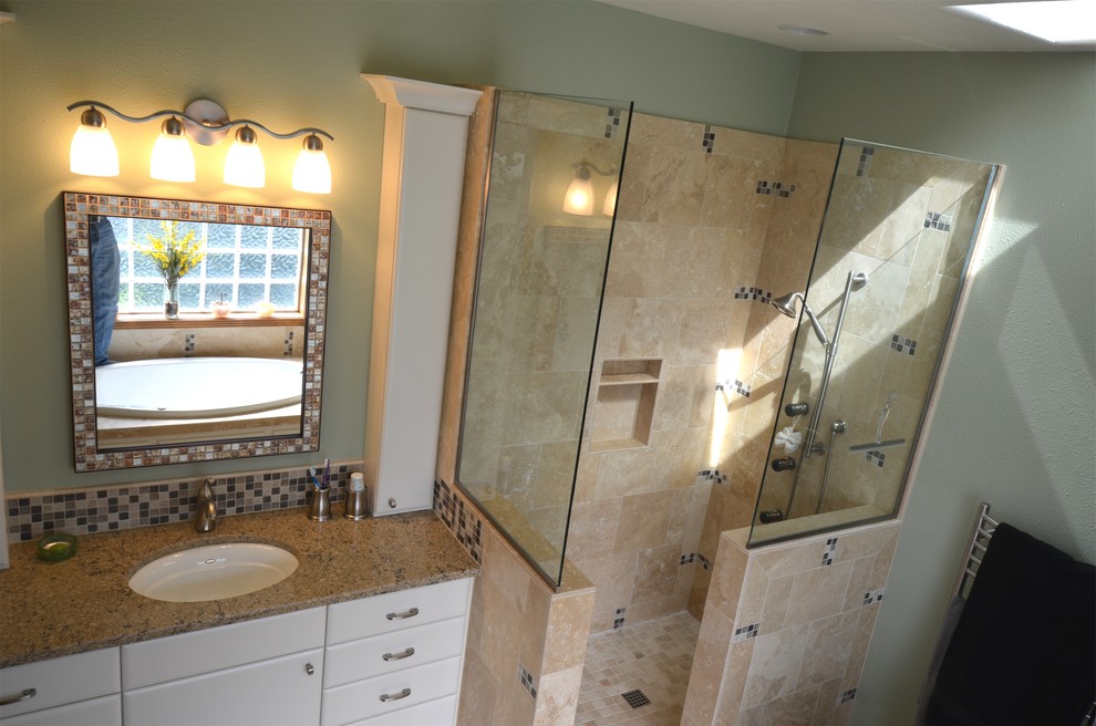 This is an example of a beach style bathroom in Portland with white cabinets, an open shower and beige tile.