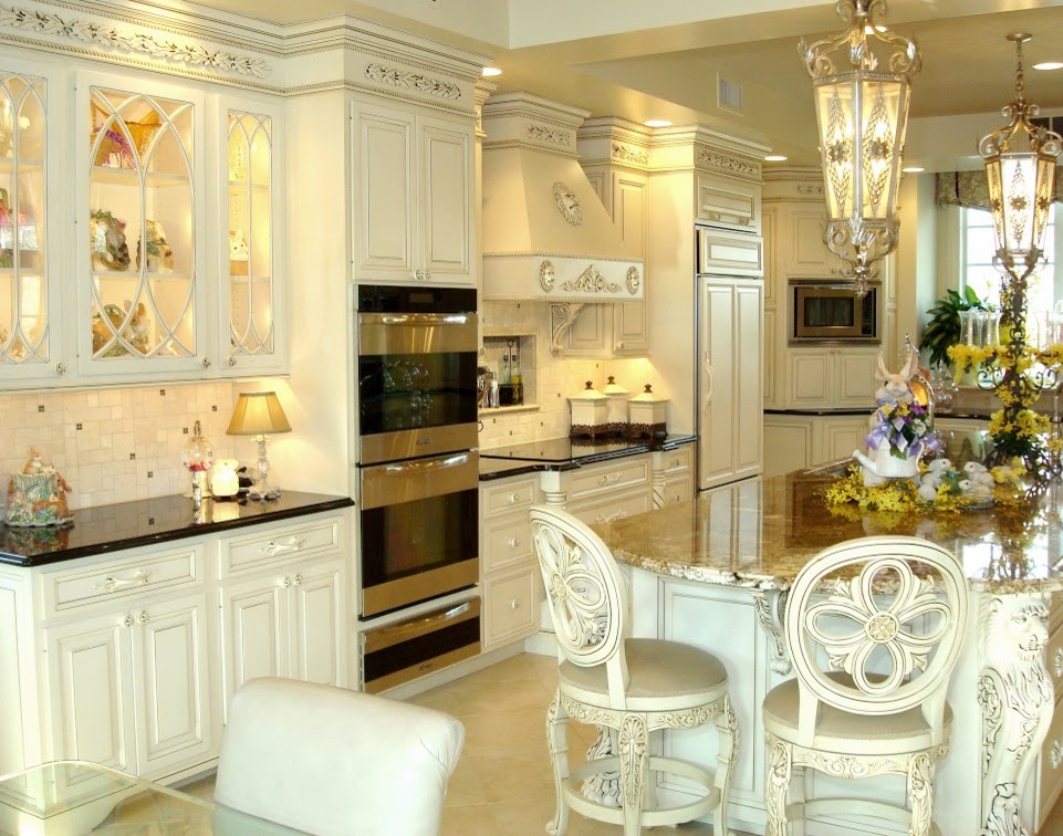 Photo of a large traditional u-shaped separate kitchen in New York with an undermount sink, raised-panel cabinets, white cabinets, granite benchtops, beige splashback, stone tile splashback, panelled appliances, ceramic floors, with island and beige floor.