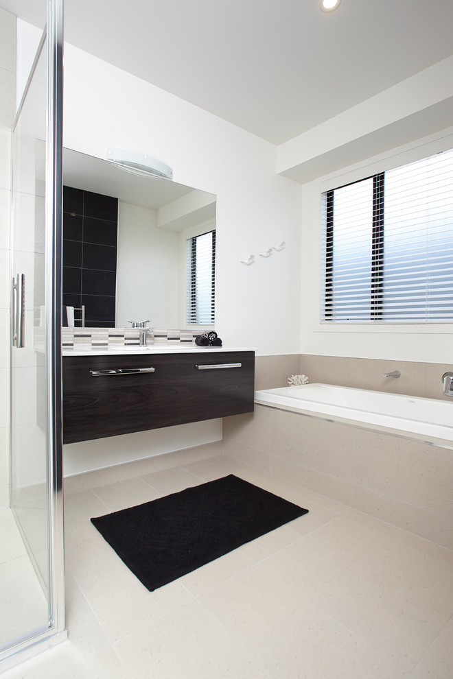 This is an example of a mid-sized contemporary master bathroom in Hamilton with a corner shower, beige tile, white walls, ceramic floors, flat-panel cabinets, dark wood cabinets and a drop-in tub.
