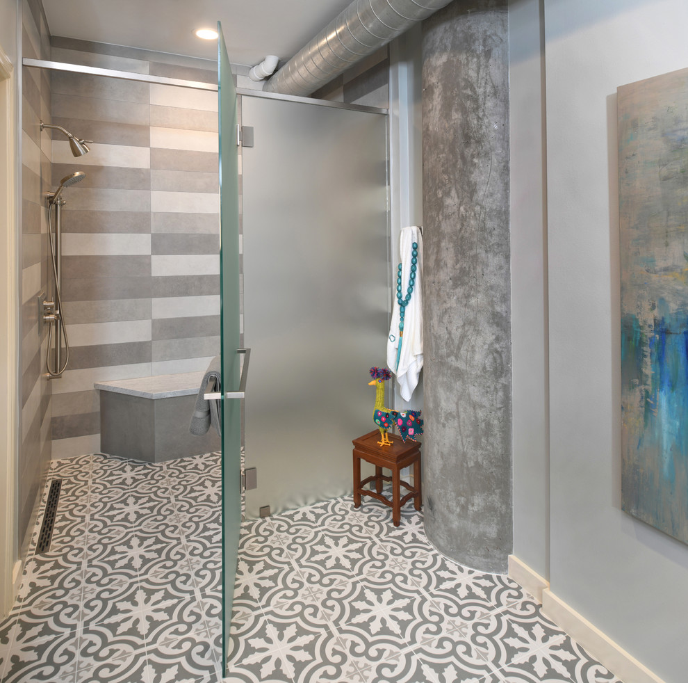 Photo of a mid-sized contemporary master bathroom in Houston with flat-panel cabinets, grey cabinets, a curbless shower, gray tile, multi-coloured tile, cement tile, a hinged shower door, grey walls, cement tiles, an undermount sink, multi-coloured floor and grey benchtops.