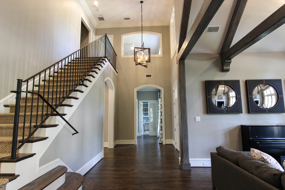 Inspiration for a large transitional dark wood floor and brown floor foyer remodel with a white front door and beige walls