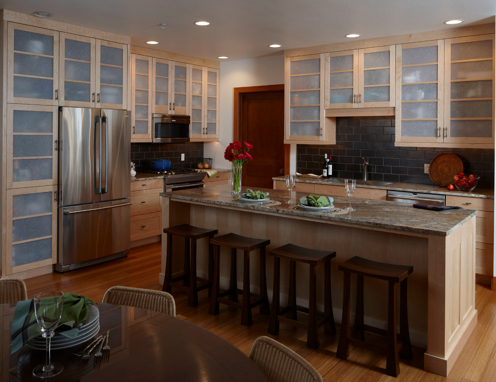This is an example of a contemporary kitchen in Milwaukee with granite benchtops and stainless steel appliances.