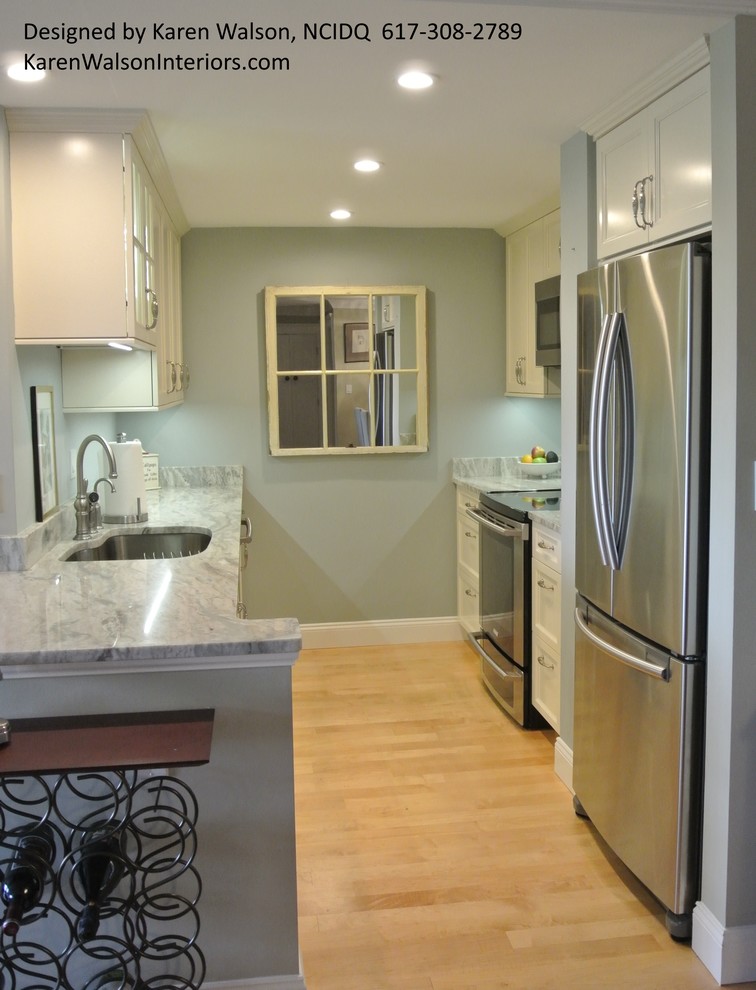 Example of a small transitional galley light wood floor eat-in kitchen design in Boston with an undermount sink, recessed-panel cabinets, white cabinets, granite countertops, stone slab backsplash, stainless steel appliances and a peninsula