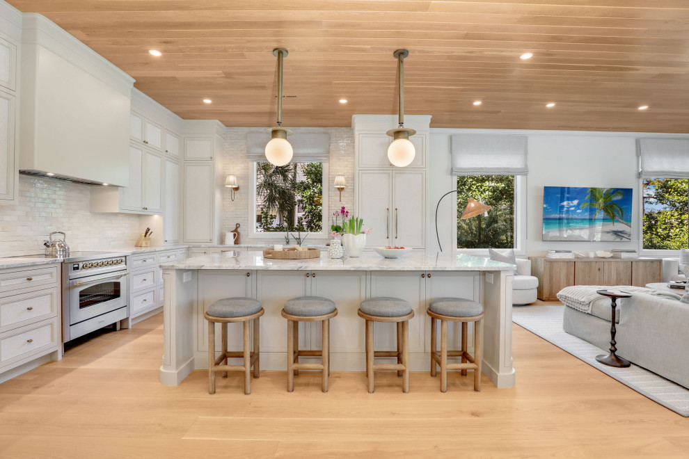 Inspiration for a transitional l-shaped light wood floor, beige floor and wood ceiling kitchen remodel with recessed-panel cabinets, white cabinets, white backsplash, stainless steel appliances, an island and white countertops