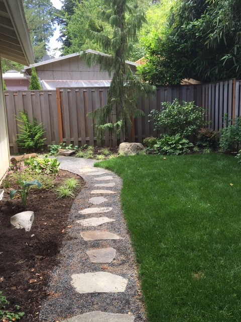 This is an example of a small traditional backyard shaded garden in Portland with a garden path and natural stone pavers.